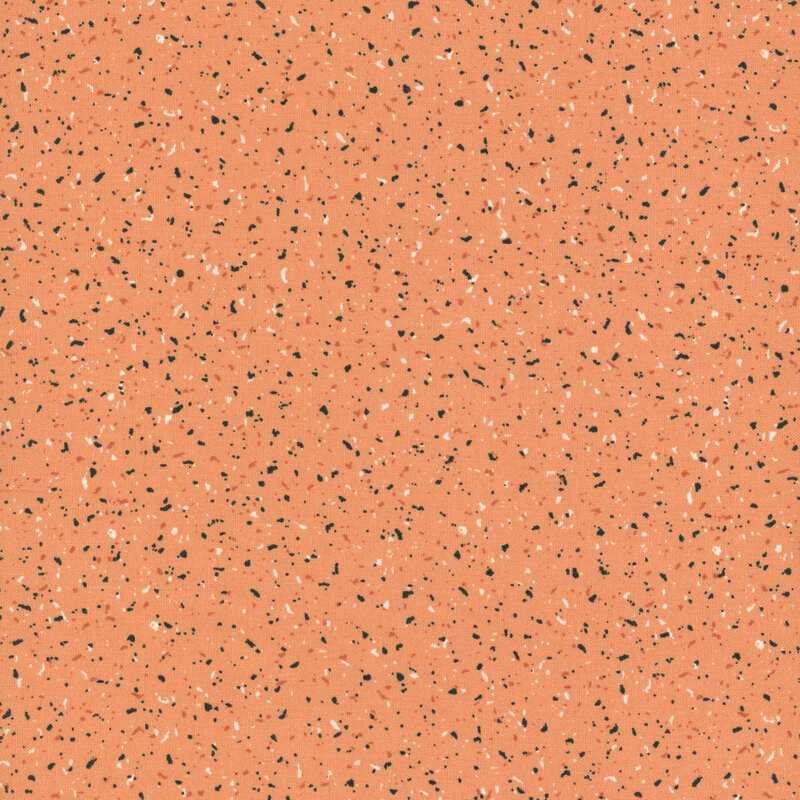 Muted pumpkin orange fabric with flecks of black, gray, white, and dark orange
