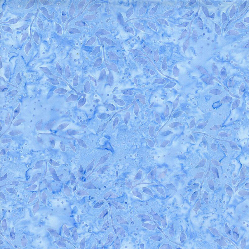 Tonal blue fabric featuring leafy branches on a mottled background.