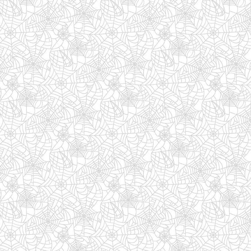 White-on-white fabric covered in spider webs.