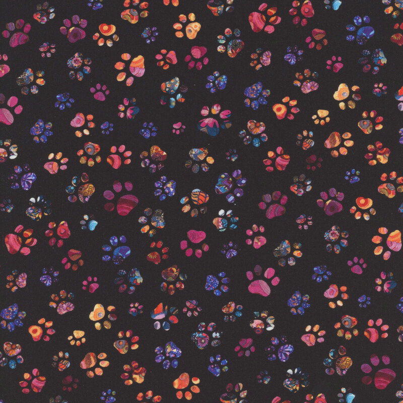 Multi-colored paw prints scattered on black fabric.