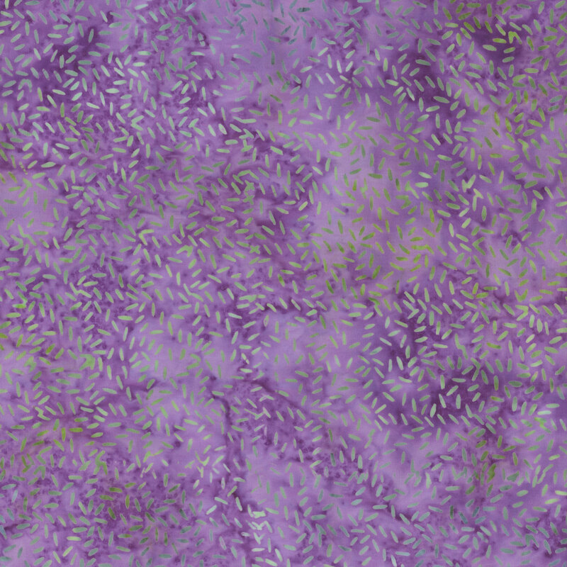 Dark purple watercolor fabric with an abstract green and blue speckled pattern