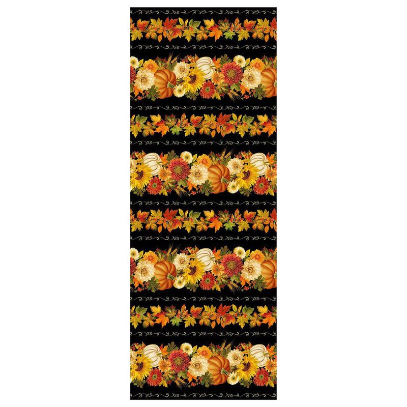 A black border stripe fabric with pumpkins, fall foliage, and scrolls. 