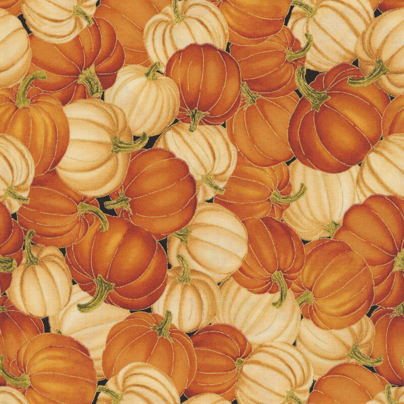 A black fabric packed with orange and white pumpkins.