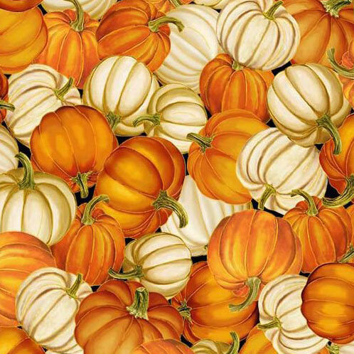 A black fabric packed with orange and white pumpkins.