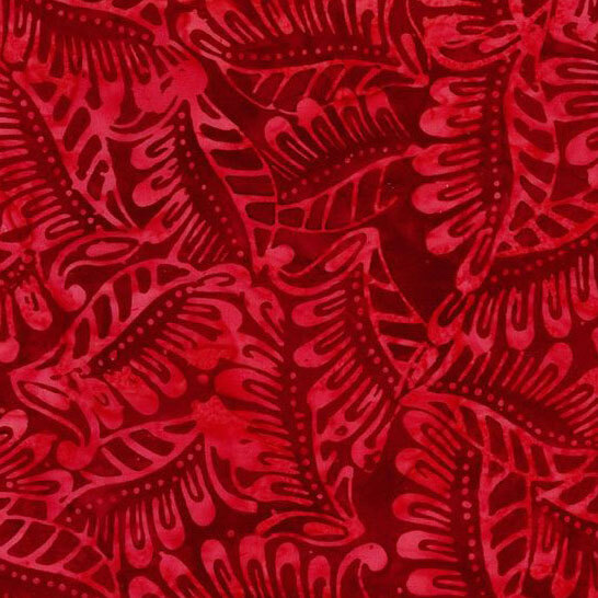 A tonal ruby red batik fabric with abstract leaves.