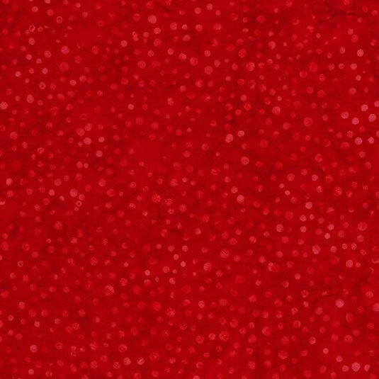 A tonal ruby red batik fabric with dots.