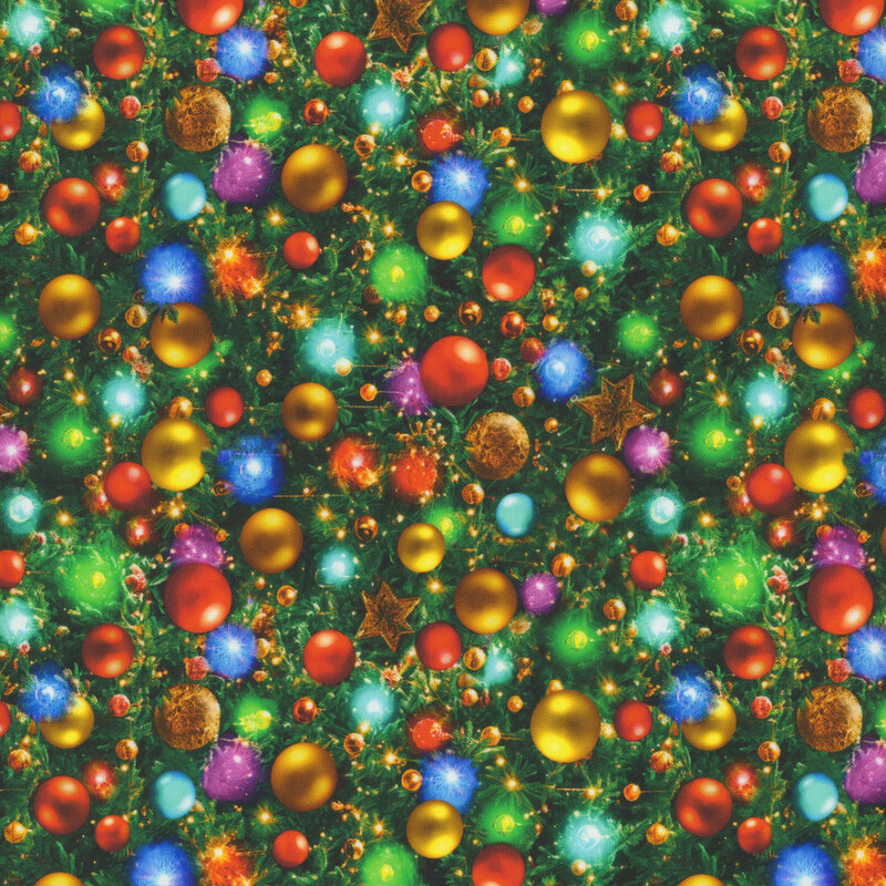 Pine branches with a dense pattern of glossy, brightly colored Christmas ornaments and twinkling Christmas lights