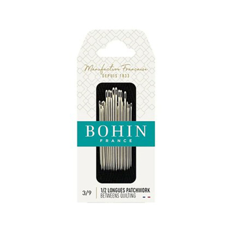 Bohin Between Quilting Needles in their decorative French packaging, isolated on a white background.