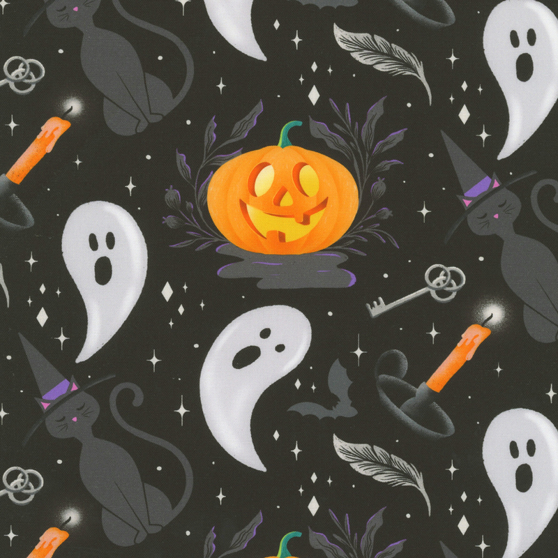 Black fabric featuring charcoal gray cats in witch hats, jack-o-lanterns, light gray ghosts, silver keys, gray bats, and orange candles with white diamond shaped stars interspersed