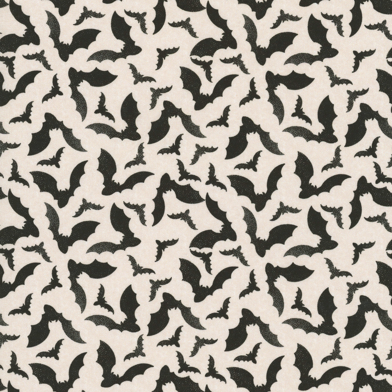 Cream fabric with a tossed pattern of black bats flapping their wings 