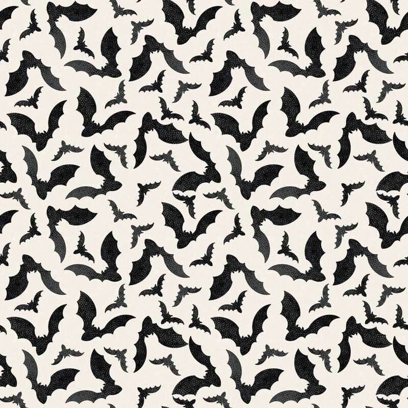 Cream fabric with a tossed pattern of black bats flapping their wings 