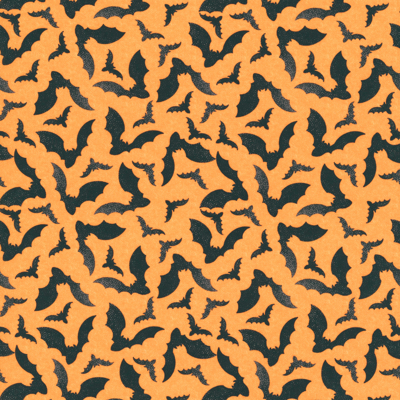 Soft orange fabric with a tossed pattern of black bats flapping their wings 