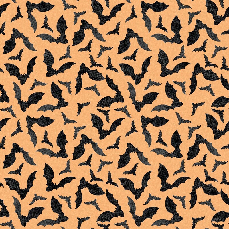 Soft orange fabric with a tossed pattern of black bats flapping their wings 