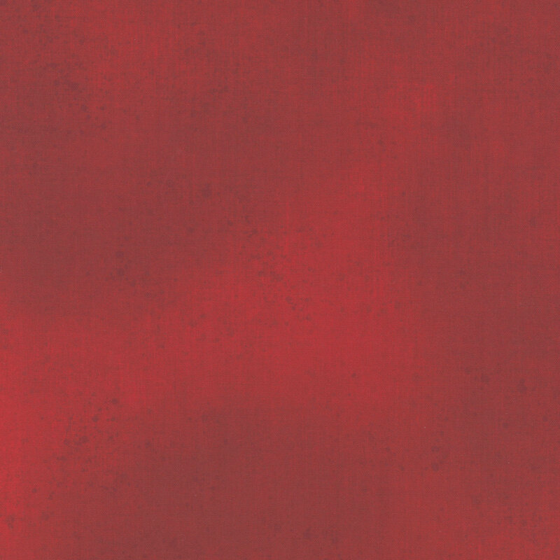 Dark red fabric with a subtle grunge texture.