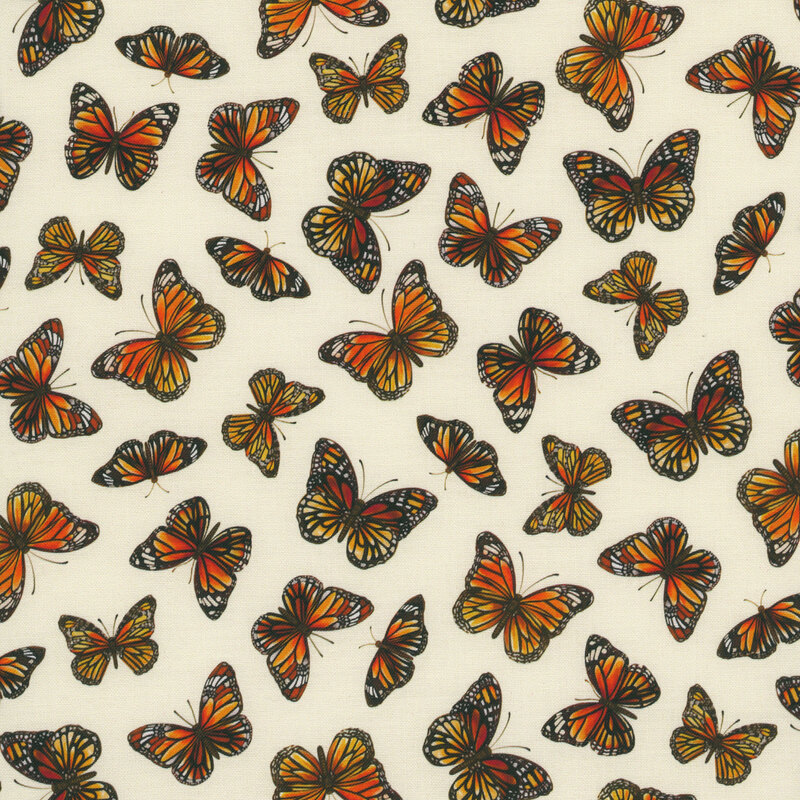 cream colored fabric with a tossed pattern of orange monarch butterflies with wings spread