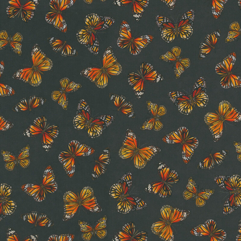 Black colored fabric with a tossed pattern of orange monarch butterflies with wings spread