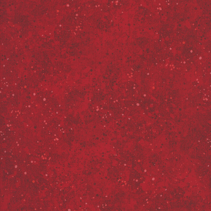 Mottled red fabric featuring tonal spots resembling paint splatter.