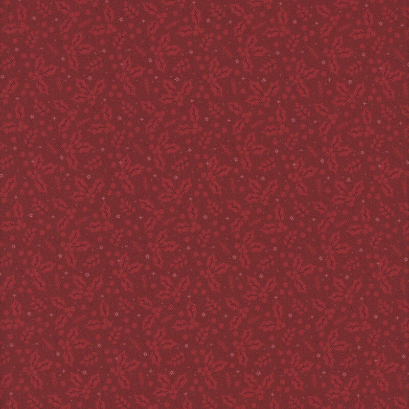 Red fabric adorned with a dense pattern of holly leaves and tiny stars.