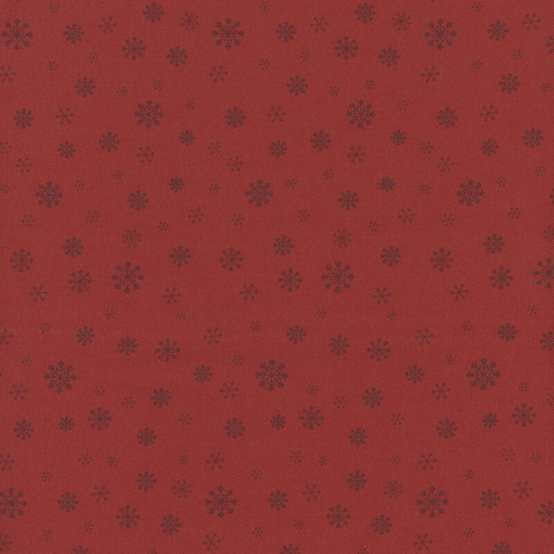 Red fabric with a delicate pattern of varying snowflake sizes.