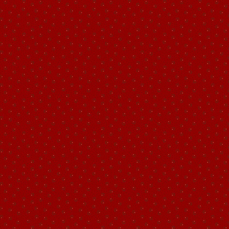 Bright red fabric with black pin dots and crescent shapes with beige stars