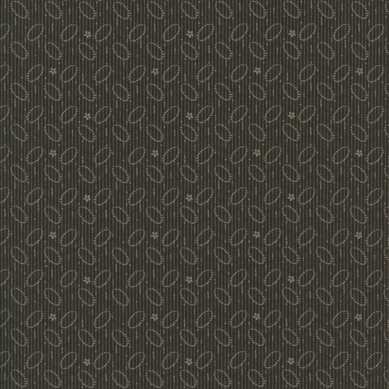 Black fabric with gray dotted vertical lines, ovals, and flowers in a primitive print