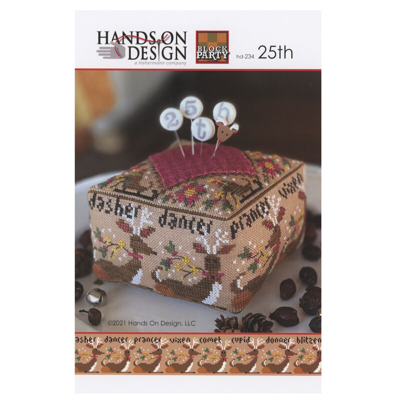 The front of the 25th - Block Party cross stitch pattern showing the completed project staged with coordinating decor.