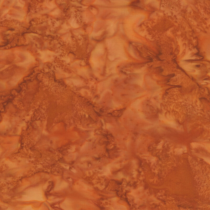 Mottled rust orange tonal batik fabric