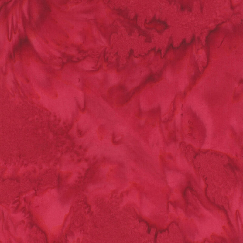 Marbled batik fabric in shades of red.