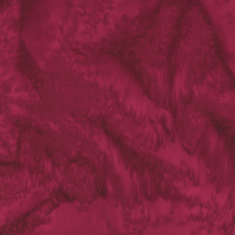 Add vivid color to your creative projects with this mesmerizing, marbled batik fabric in shades of ruby red.