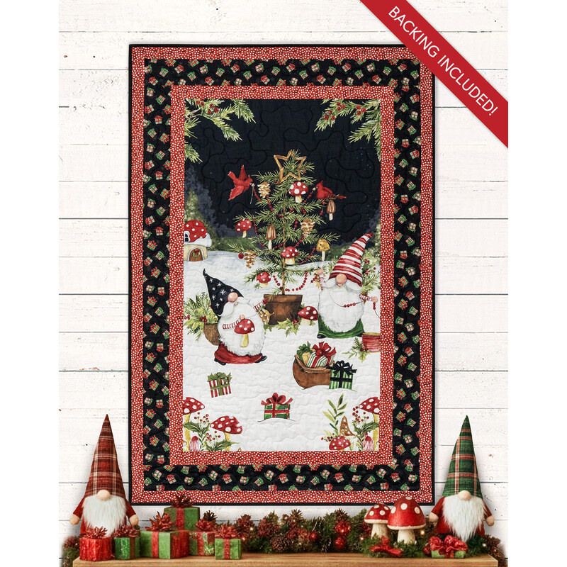 The completed Merry Gnome-ments panel quilt colored in black and red fabric featuring gnomes decorating a charming Christmas tree hung on a white-paneled wall and bordered by coordinating gnome decor.
