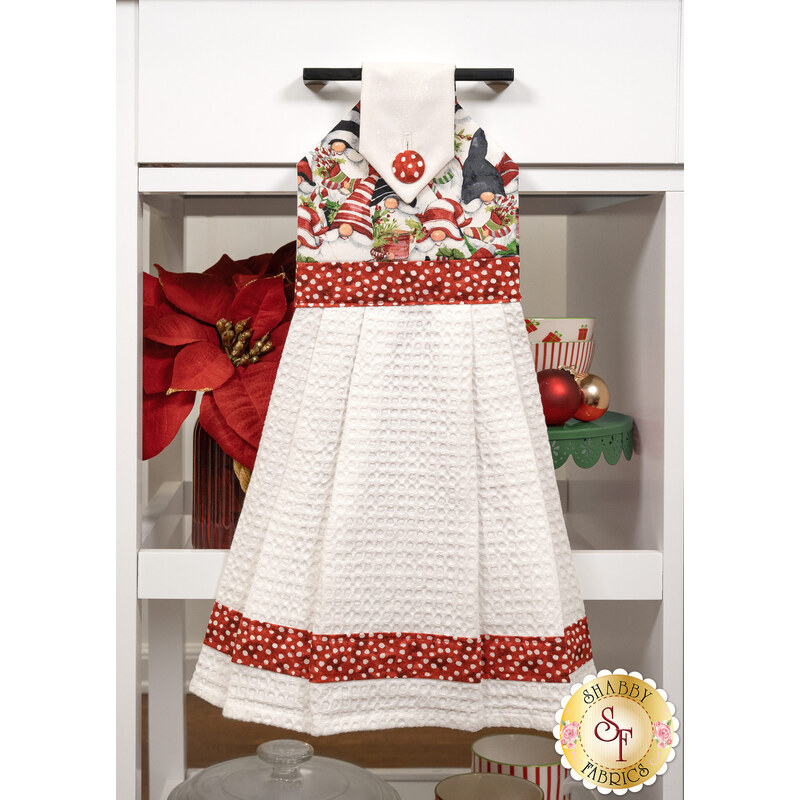 The Hanging Towel, colored in white and red spotted fabrics from the Merry Gnome-ments collection, staged on a white kitchen drawer with coordinating decor.