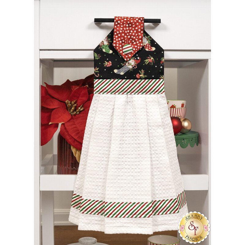 The Hanging Towel, colored in black, white and red striped fabrics from the Merry Gnome-ments collection, staged on a white kitchen drawer with coordinating decor.