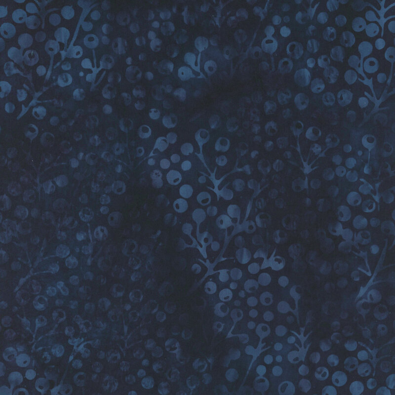 Indigo blue mottled fabric with a subtle tonal pattern of holly berries