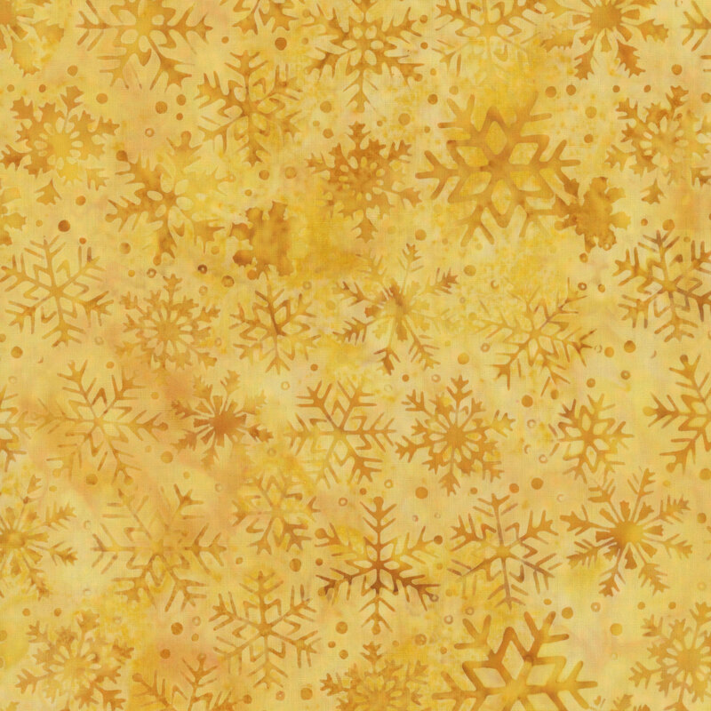 Mottled butterscotch fabric with pattern of dark gold tonal snowflakes