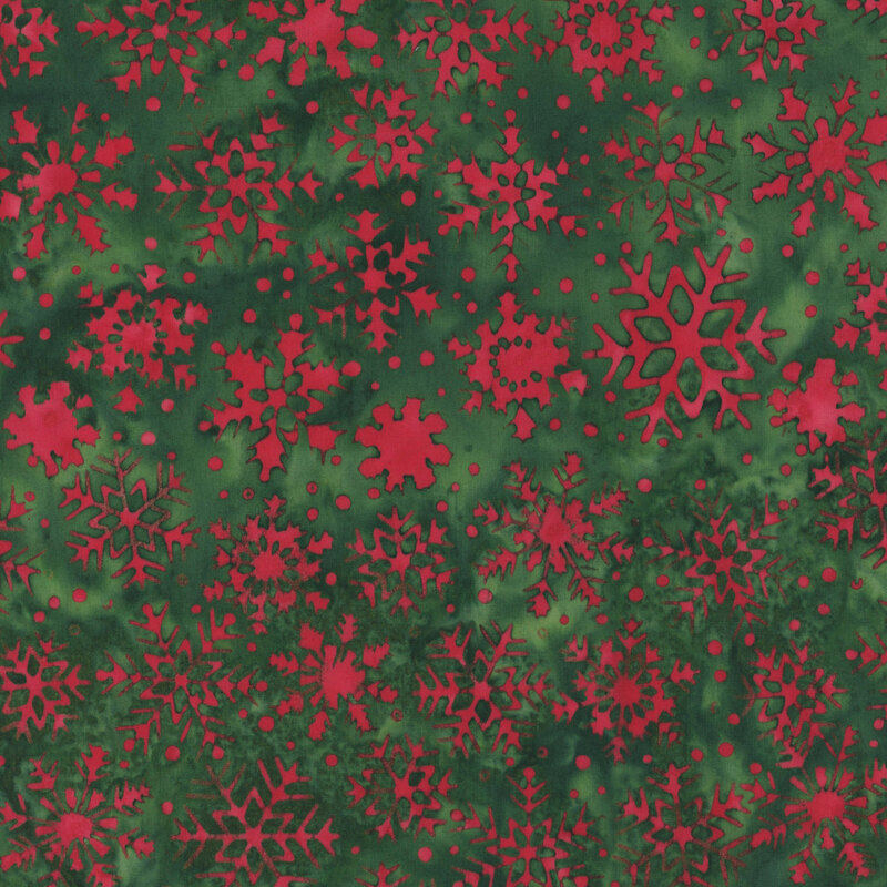 Mottled forest green fabric with pattern of bright crimson snowflakes