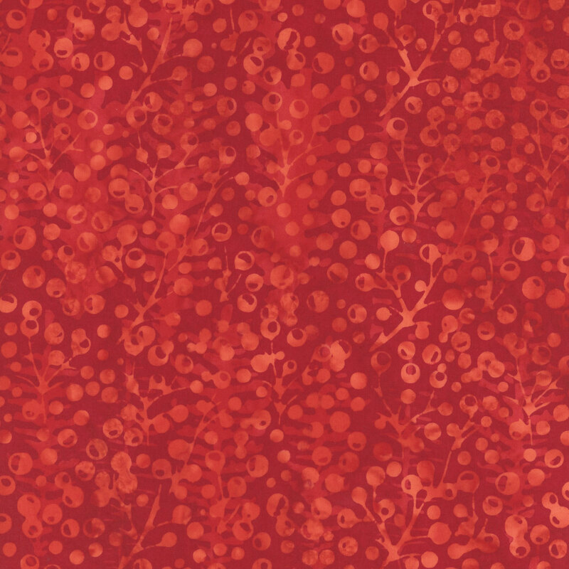 Scarlet mottled fabric with a bright tonal pattern of holly berries