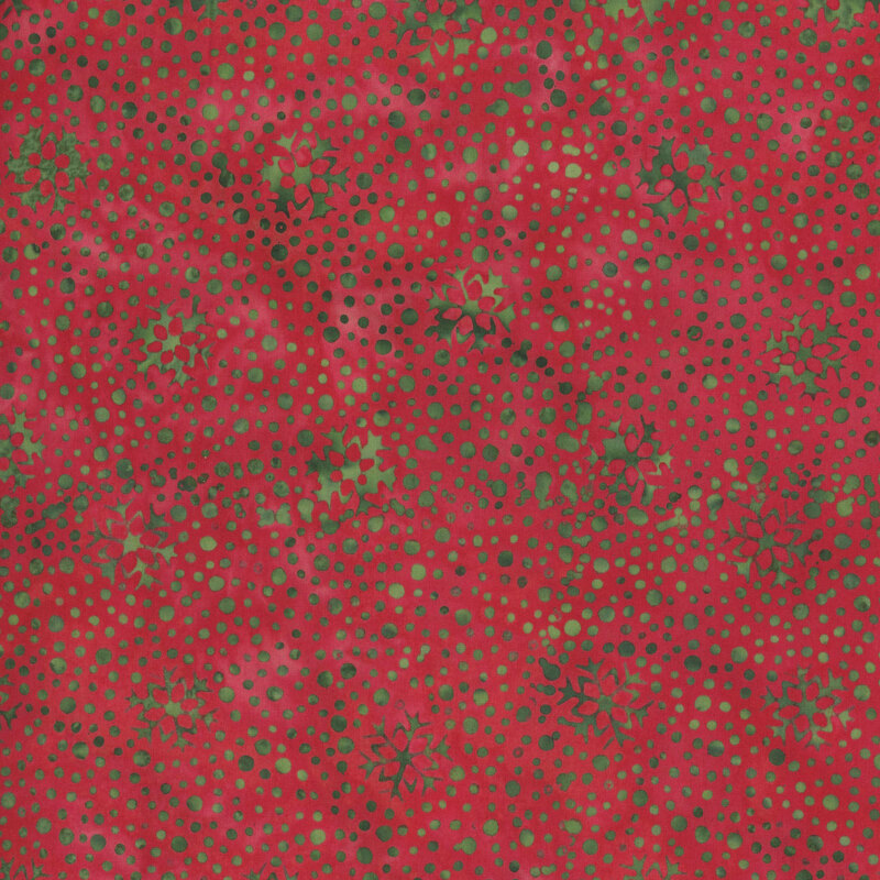 Crimson red fabric with a dense pattern of mottled green dots and snowflakes