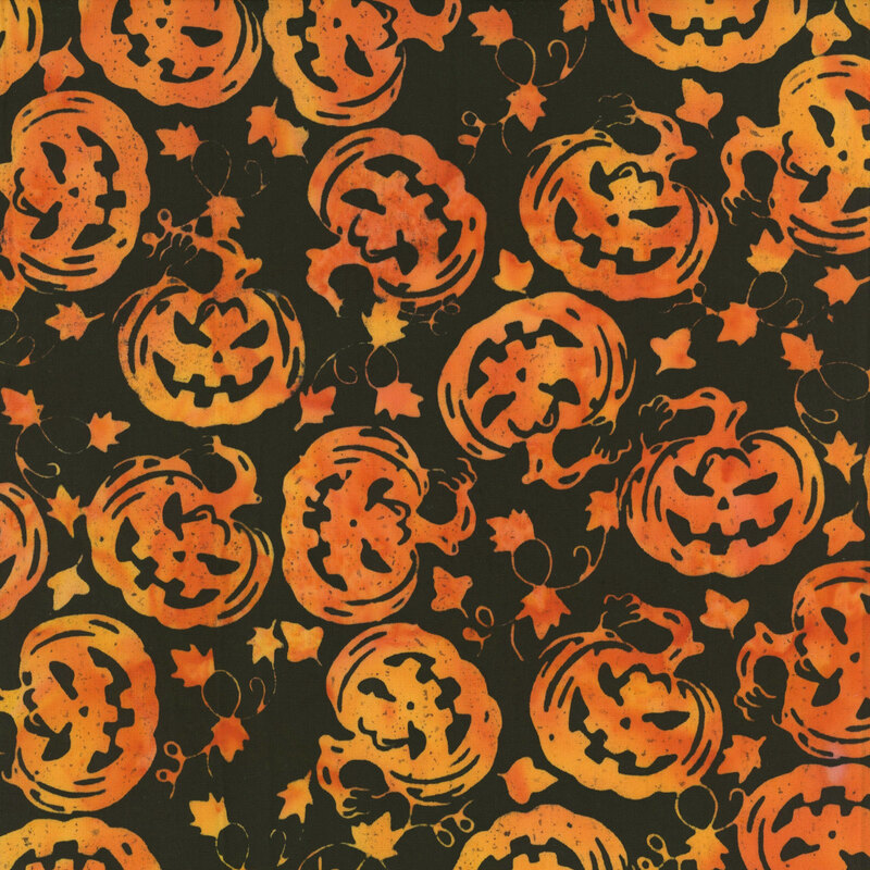 Black fabric featuring frightening mottled orange silhouette carved pumpkins.