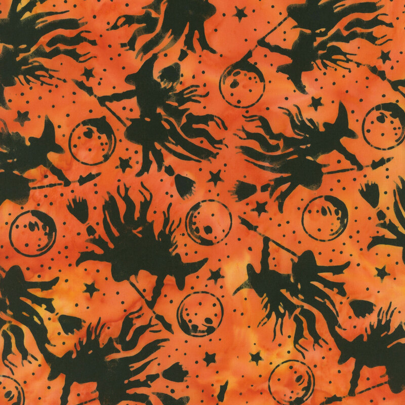 Mottled orange fabric with flying witches, moons, and stars.
