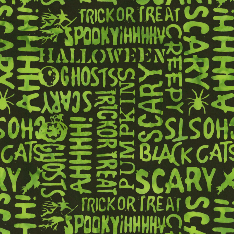Pitch black fabric featuring Halloween-themed words in bold, lime green lettering.