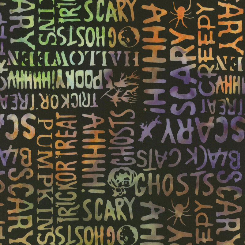 Pitch black fabric featuring Halloween-themed words in bold, mottled green, orange, and purple lettering.