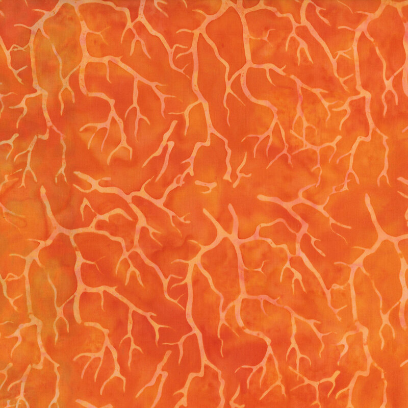 Mottled orange fabric with tonal hanging tree branches.