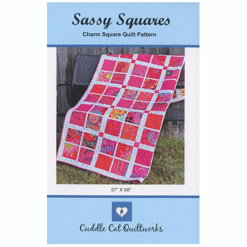 The front of the Sassy Squares quilt pattern displaying the finished product against a wood fence.