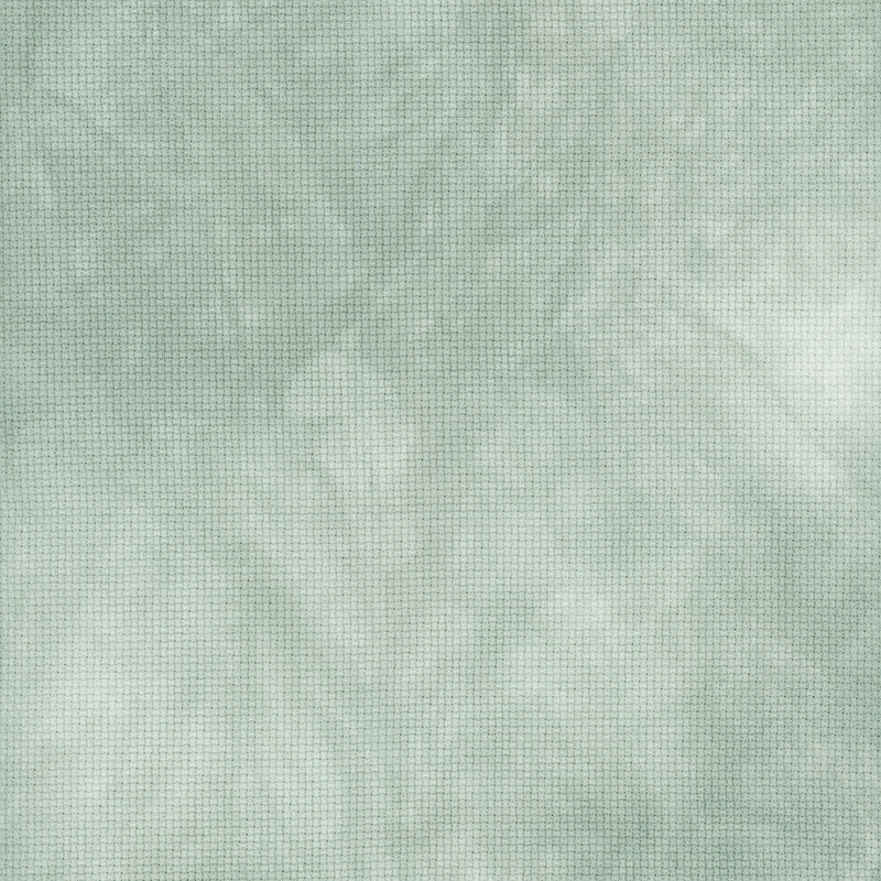 A close up swatch of marbled 14ct aida cloth in a muted sage green color by Fabric On A Whim.