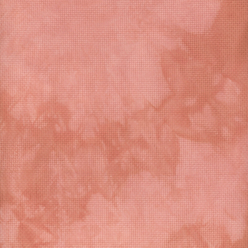 A close up swatch of marbled 14ct aida cloth in a salmon pink color by Fabric On A Whim.