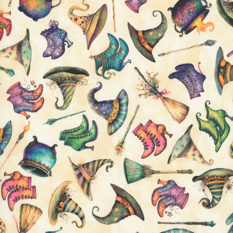 Mottled tan fabric tossed with pointed witch hats, high-healed boots, cauldrons, and wands.