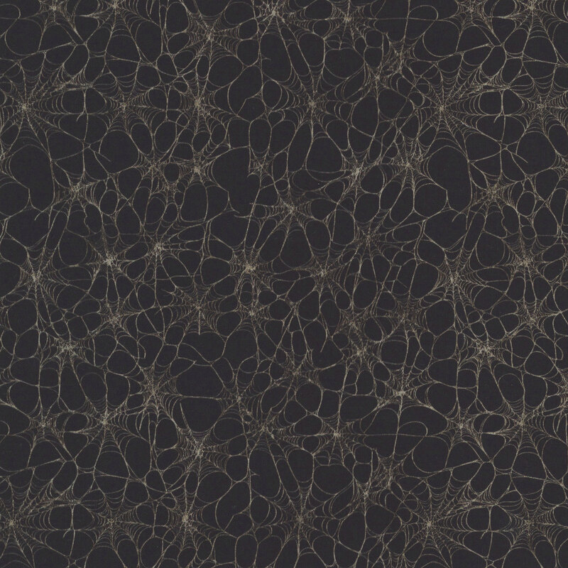 Pitch black fabric filled with white spider webs.