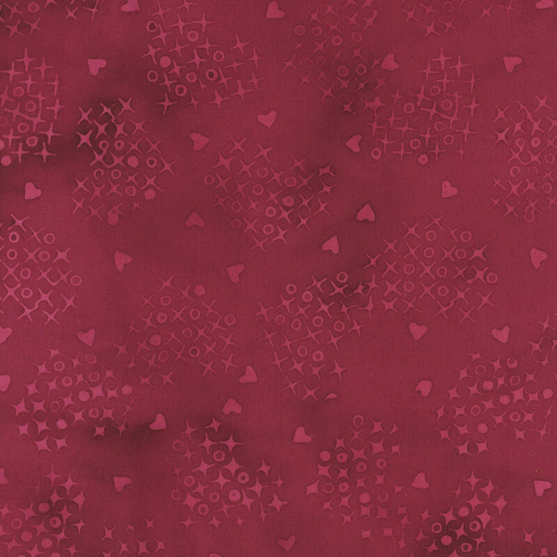 Mottled maroon fabric with a heart shaped pattern of x's and o's with interspersed hearts in tonal, light red