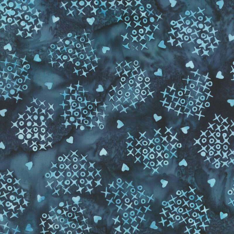 Mottled indigo fabric with a heart shaped pattern of x's and o's with interspersed hearts in aqua