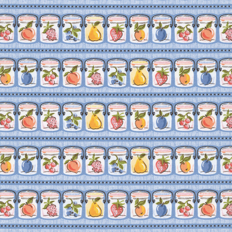 Rows of canning jars holding fresh fruits of the season on azure blue fabric.